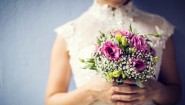 45182240 - woman holding colorful bouquet with her hands in wedding day
