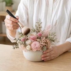 柔らかいブラシで花のほこりを軽く払う様子